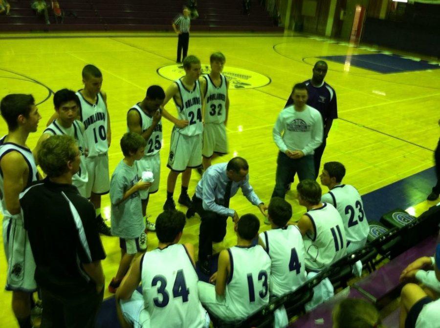 Coach Chris Lavdiotis motivates the mens varsity basketball team after the third quarter in their game against Kelseyville. For the 4th quarter, Piedmont put in his second string players to hold their 67-26 lead.