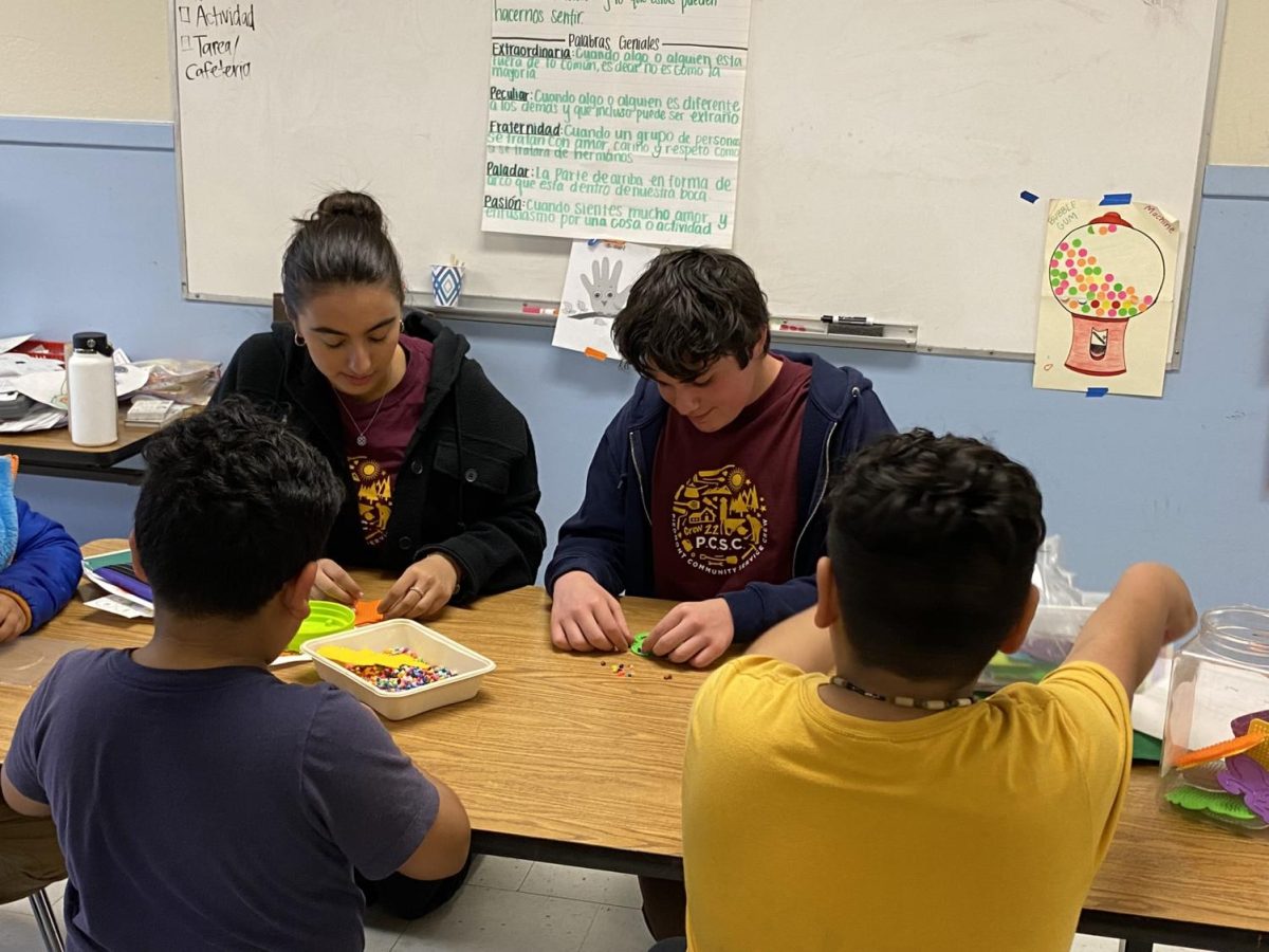 PCSC volunteers Julia Banuelos and Joseph Blumberg tutoring Bridges students