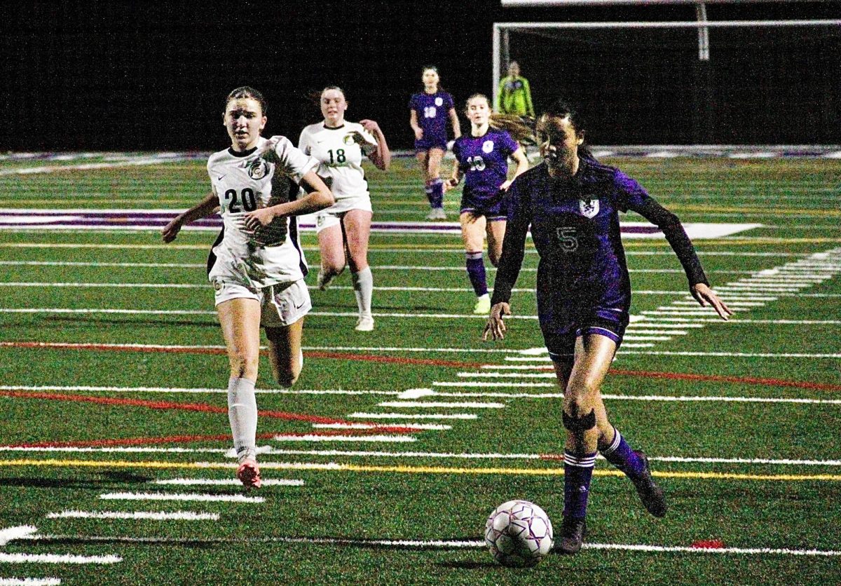 Freshman Kyla Williams runs the ball up the field during the game against Castro Valley on Jan. 14 at Witter. The Lady Highlanders won 5-2 against the Trojans