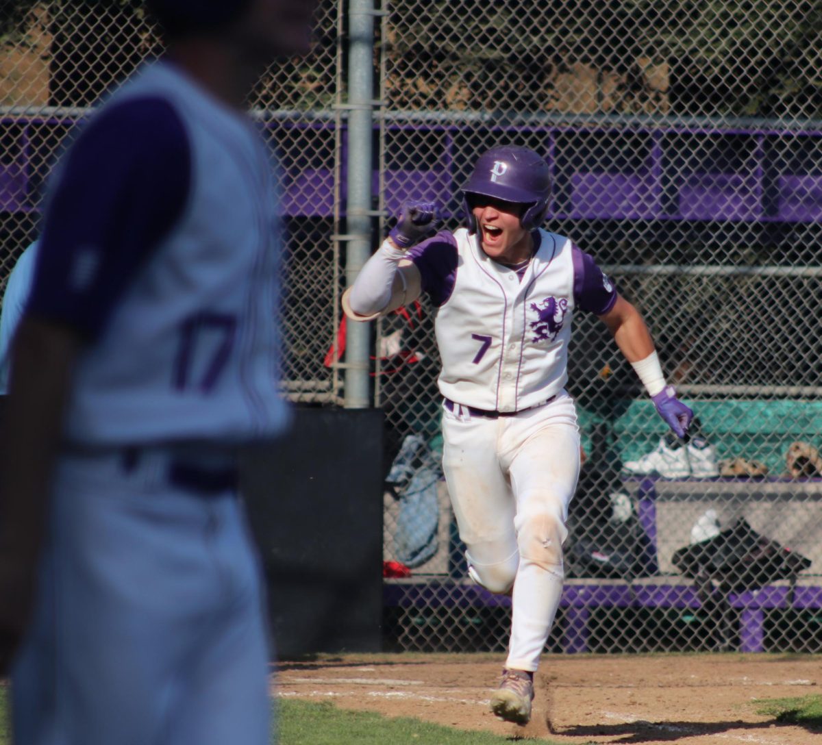 Senior Will Parker joyously runs to first base after a strong hit against Berkeley on April 30.
