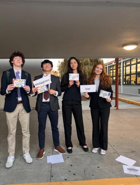 Juniors Marius Arno, Maddox Ma, Geneva Johnson, and Laurel Minor holding their delegate awards.