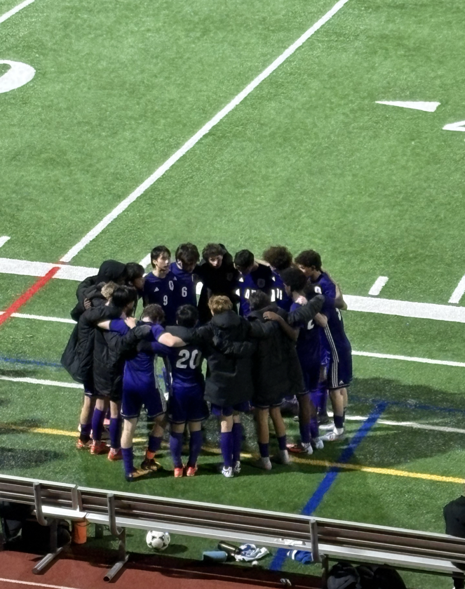 The boys varsity team huddles during half time