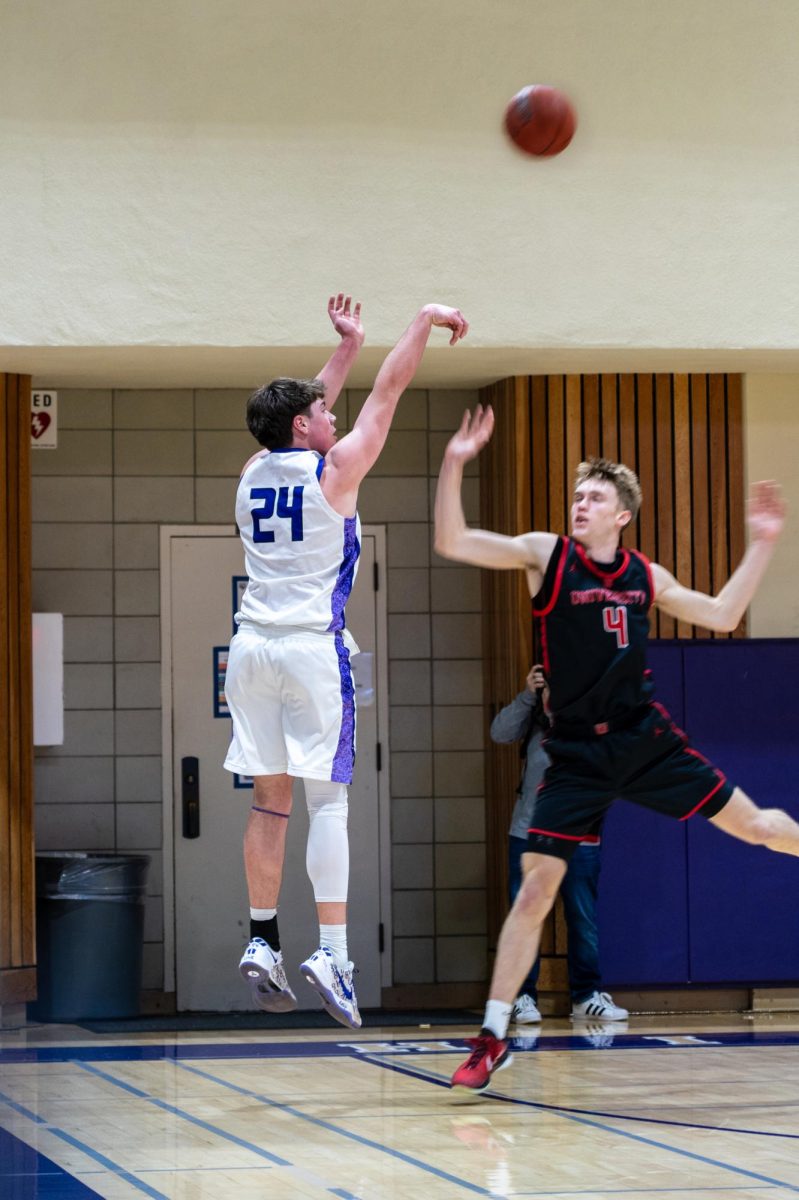 Senior PJ Brayer shoots a 3-pointer jump shot in the first quarter.