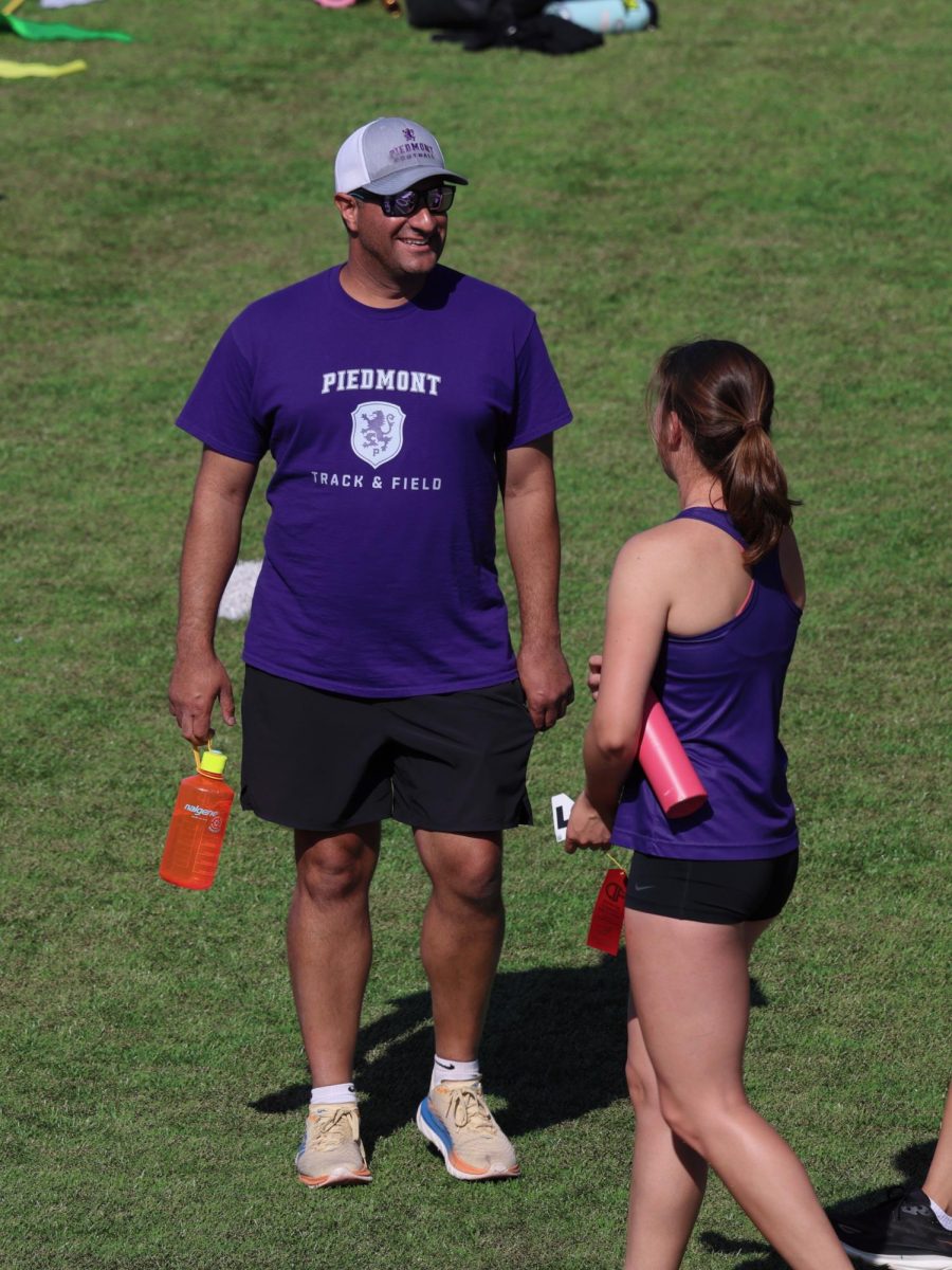 Assadi giving coaching advice to PHS alum and track athlete Ella Yasar.