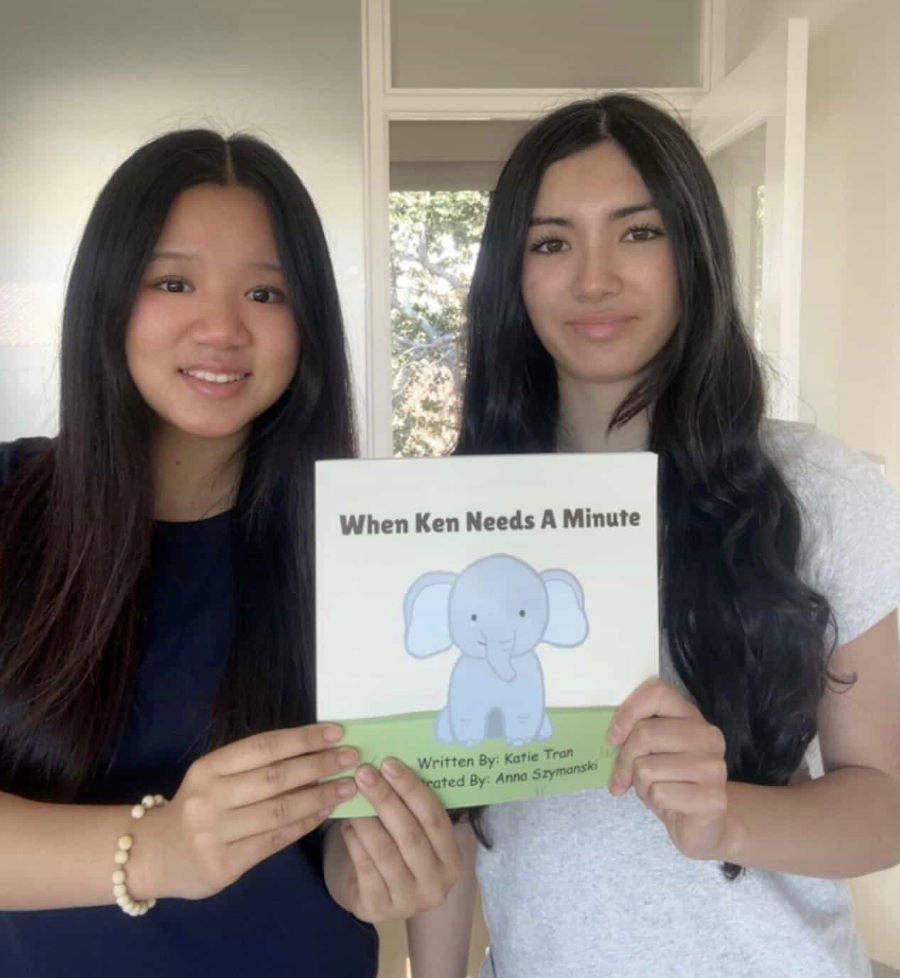 Katie Tran and Annie Szymanski displaying their newly published children’s book. 