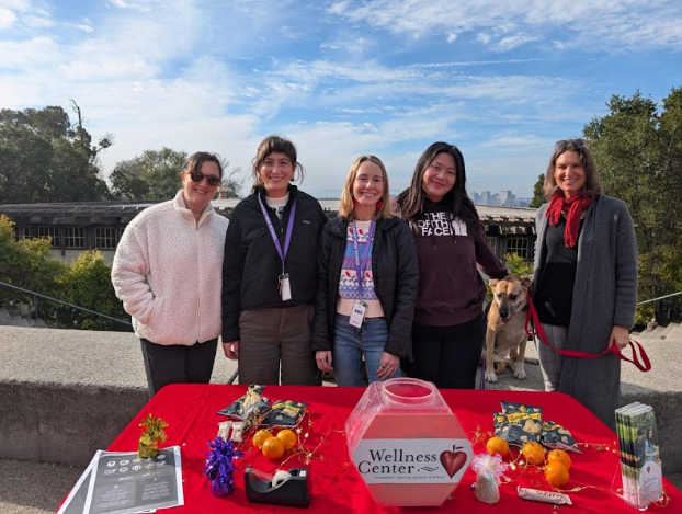 Wellness center staff hands out snacks with their therapy dog during 1st semester finals