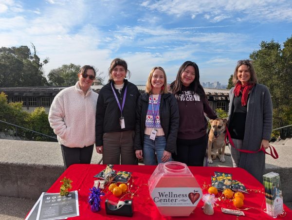 Dr. Sari Sanghvi, Kimmy Demkovich, Emily Goodwin, Maddy Sage, Dr. Alisa Crovetti set up with snacks and therapy dog during finals week.